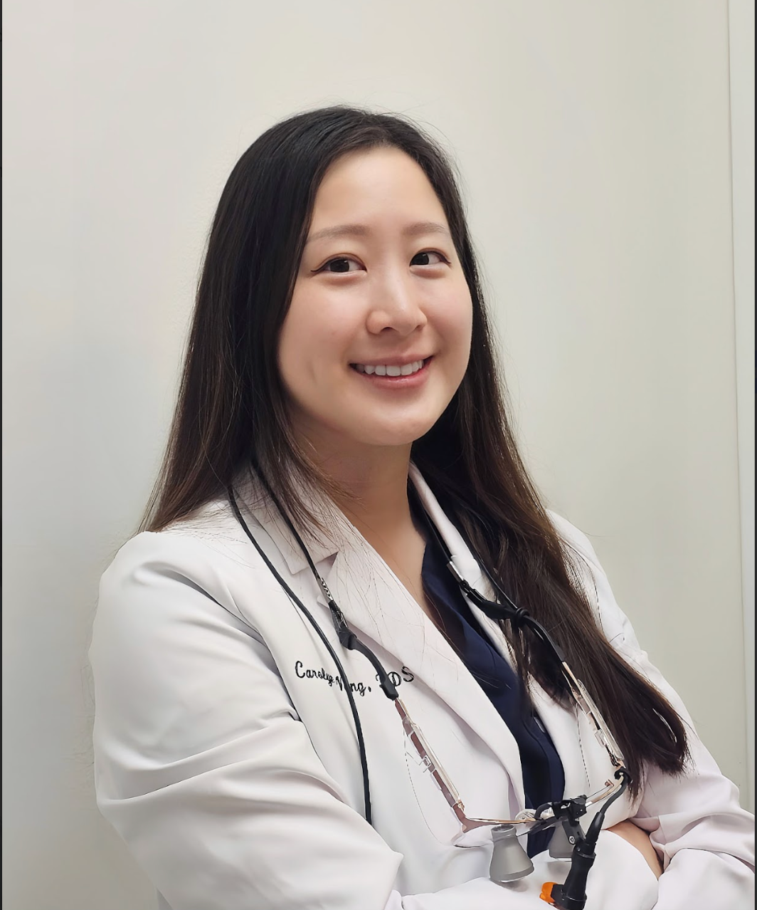 a woman in a white coat with the name candy on it