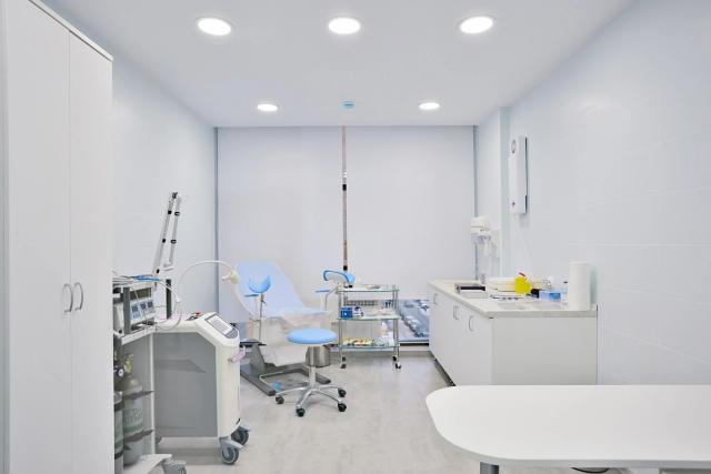 an empty dental office with a dental chair and dental equipment .
