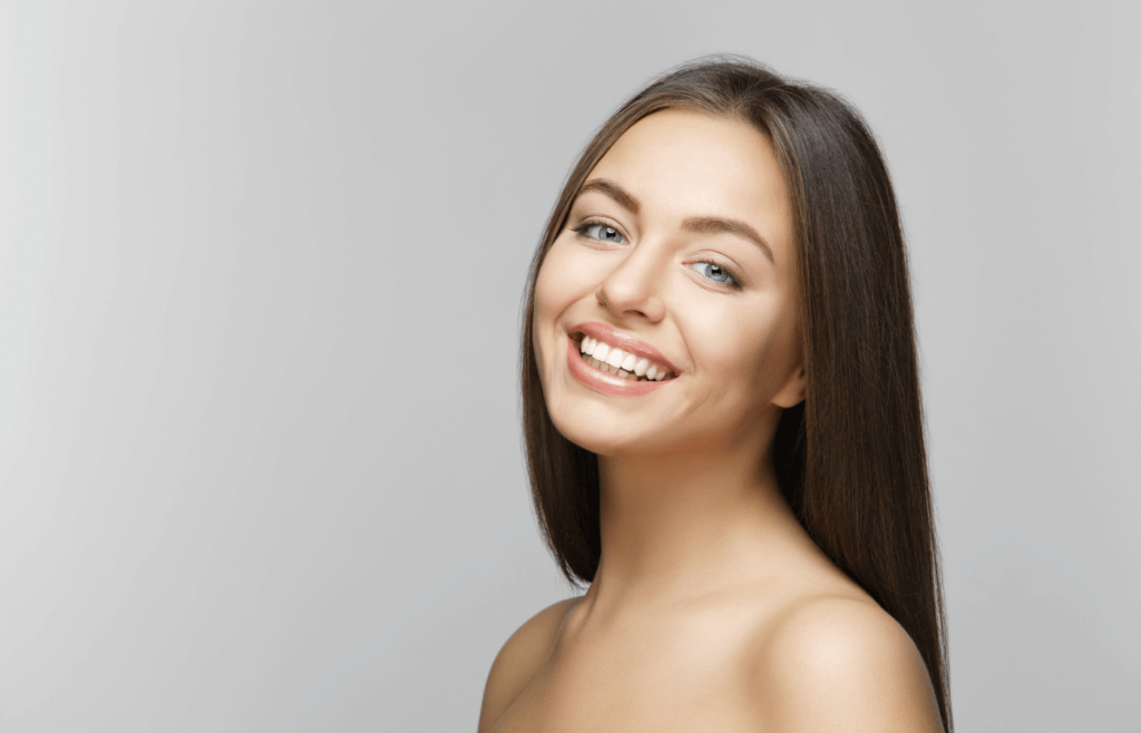 a woman with long hair is smiling for the camera
