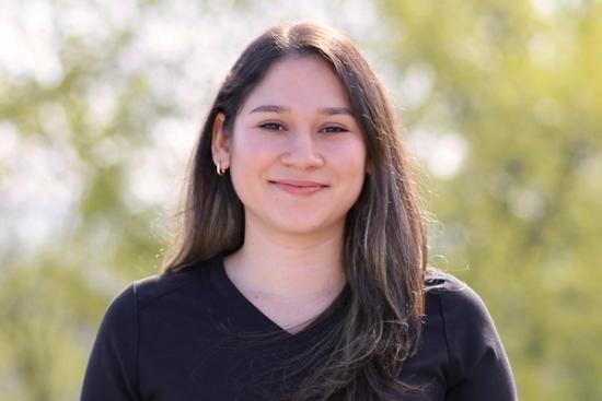 a woman in a black shirt is smiling for the camera .
