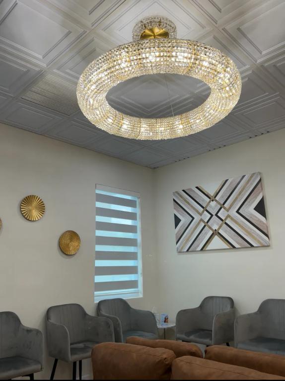 a waiting room with a large chandelier hanging from the ceiling