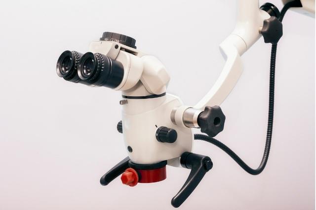 a close up of a dental microscope on a white background .