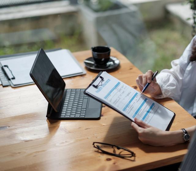 a man and a woman are sitting at a table looking at a resume .