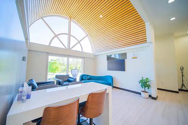 a living room with a couch , chairs , a table and a television .