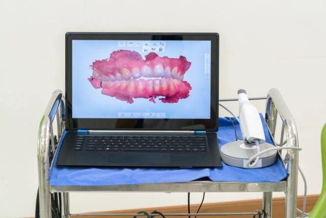 a laptop computer is sitting on top of a metal cart .