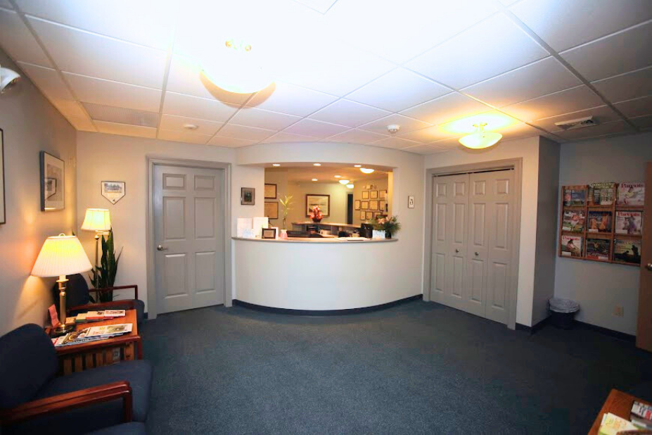 a hallway with a few certificates on the wall including one that says diploma