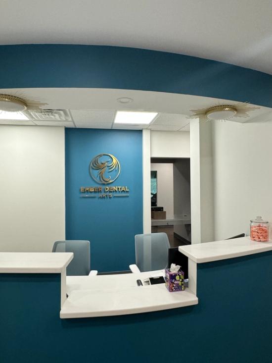 a long hallway in a hospital with glass doors and white walls .