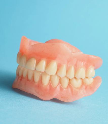 a close up of a denture on a blue background .
