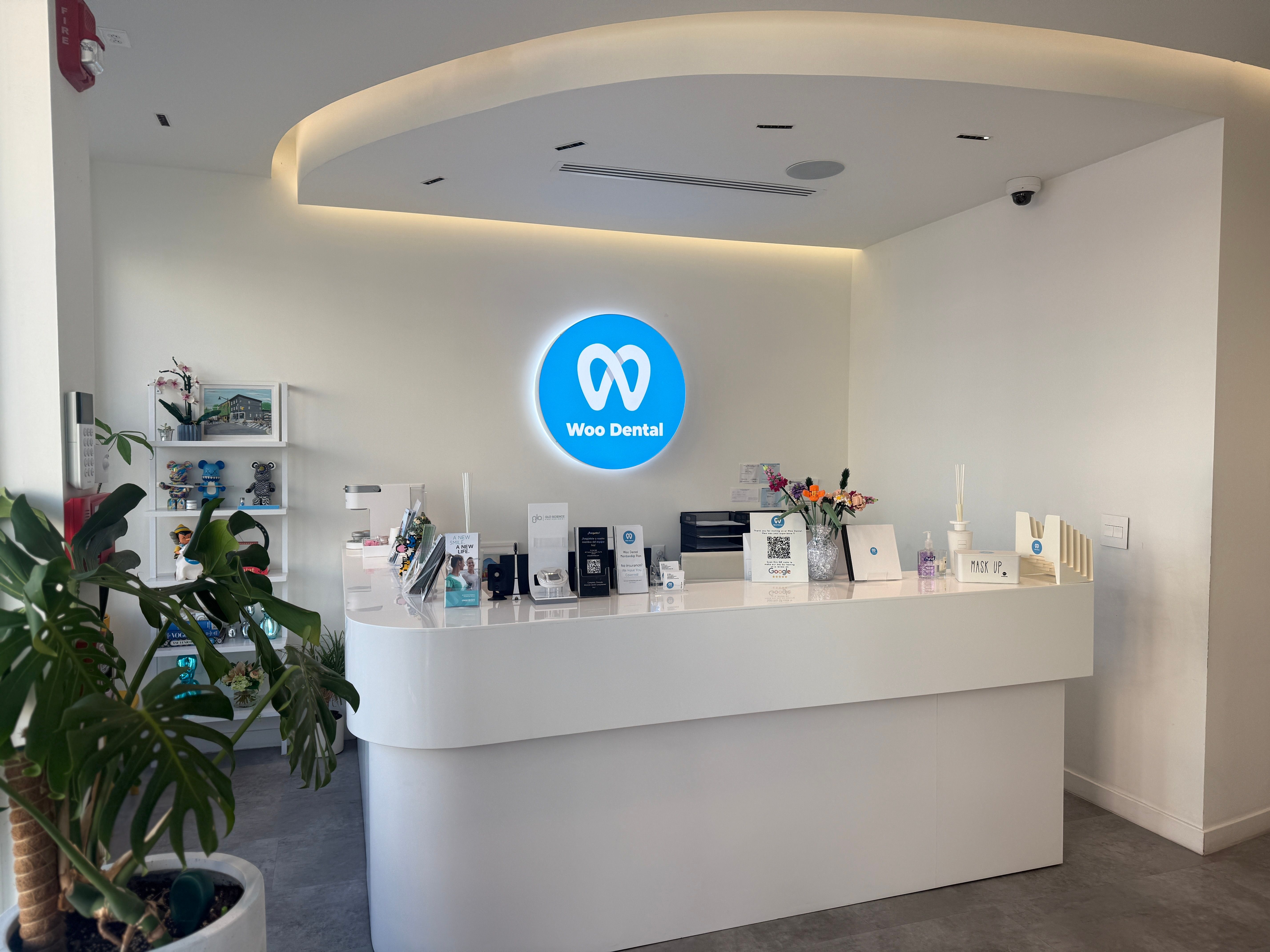 a dental office with a white counter and a blue sign on the wall .