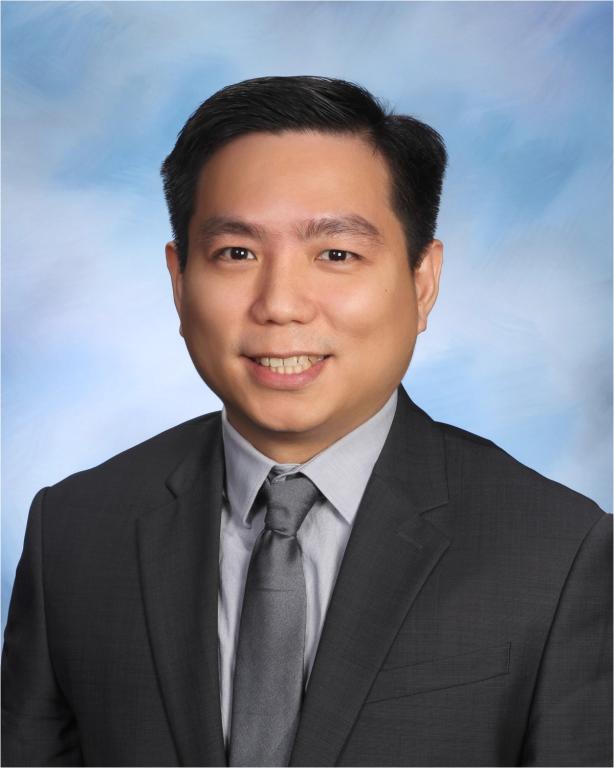 a man in a suit and tie smiles for the camera