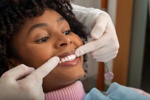 a woman is getting her teeth examined by a dentist .