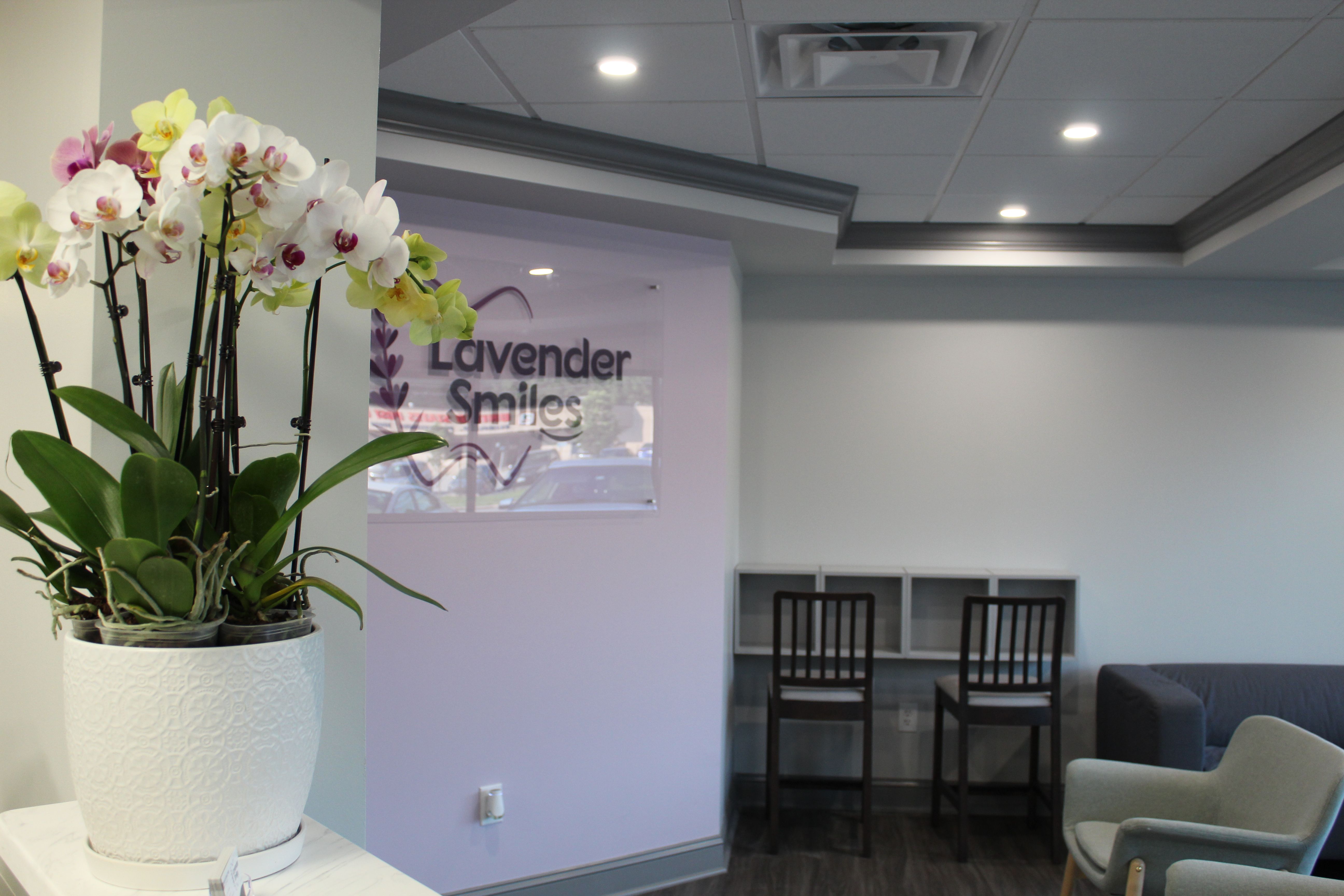 a vase of flowers is sitting on a table in a waiting room .