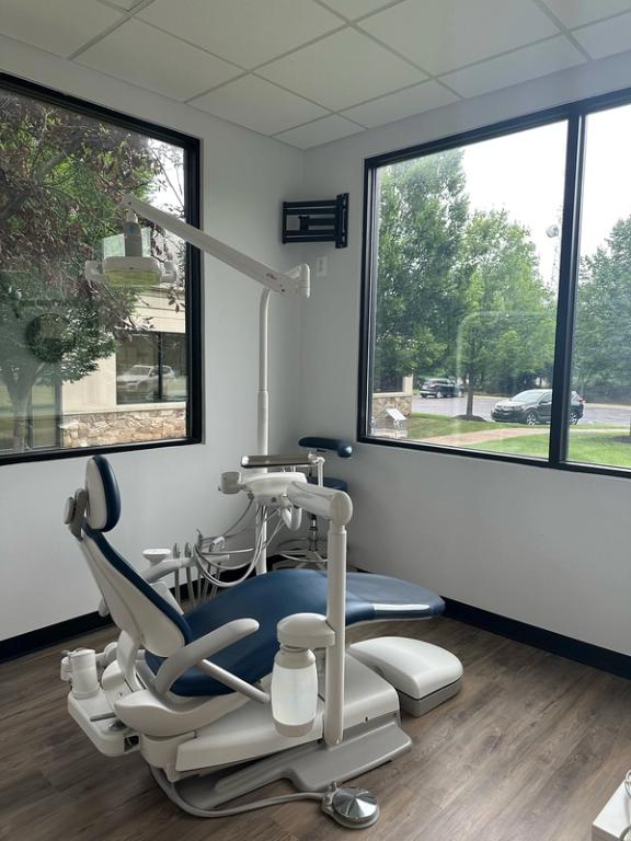 a dental office with a dental chair and a large window