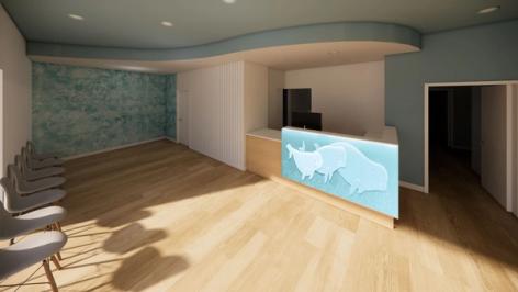 A clinic waiting room with light wood floors, grey chairs, a blue textured accent wall, and a reception desk featuring a backlit rhino family design.