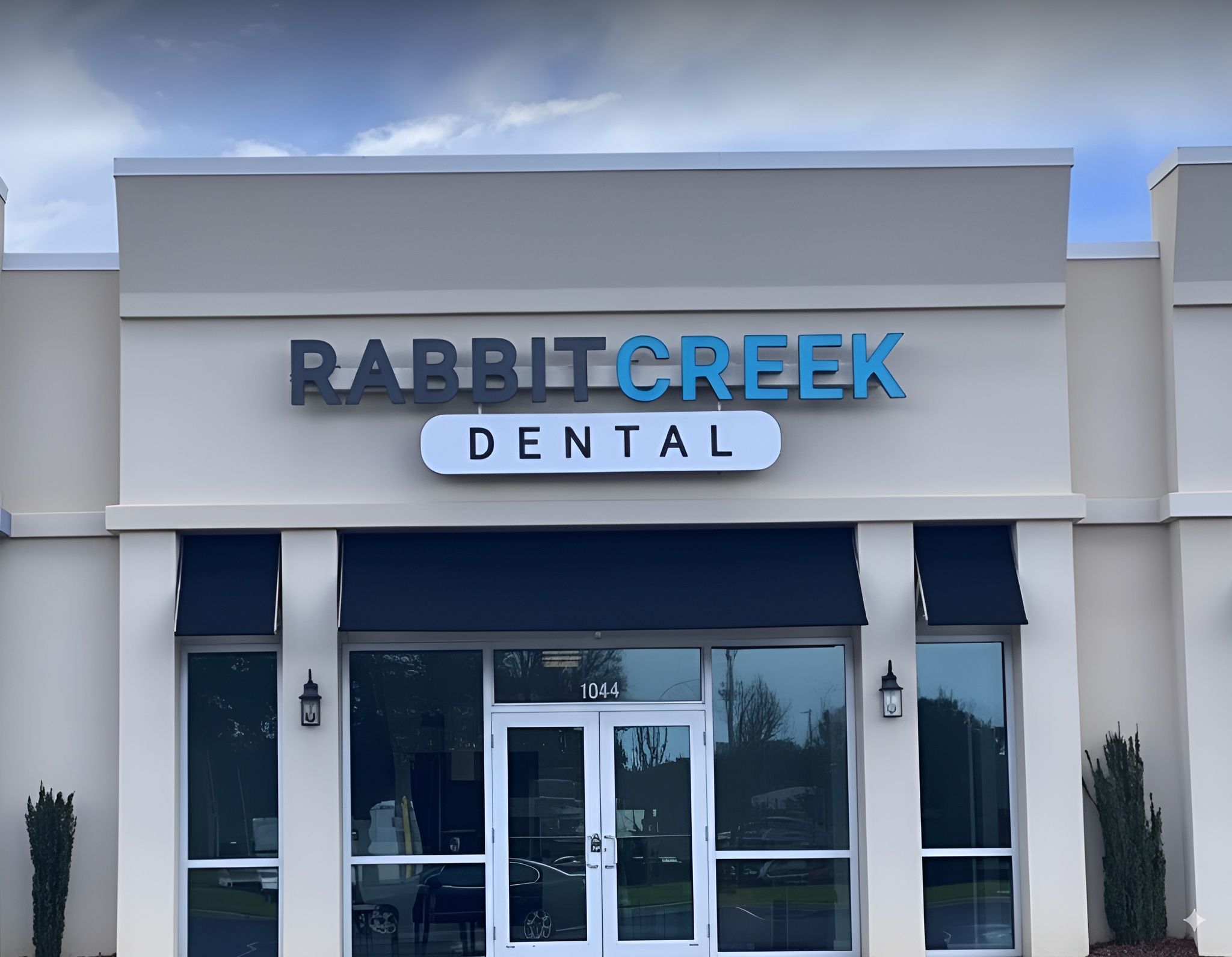 the front of a dental office with a sign that says `` rabbit creek dental '' .