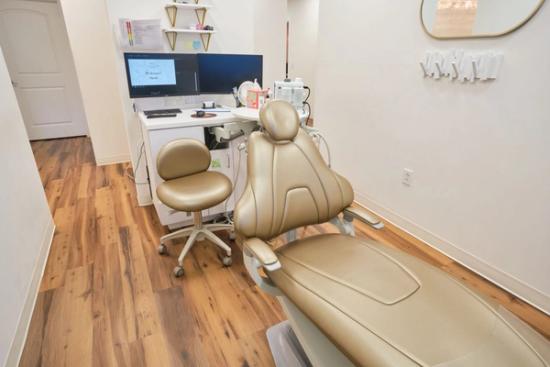 a waiting room with chairs and a flat screen tv on the wall .