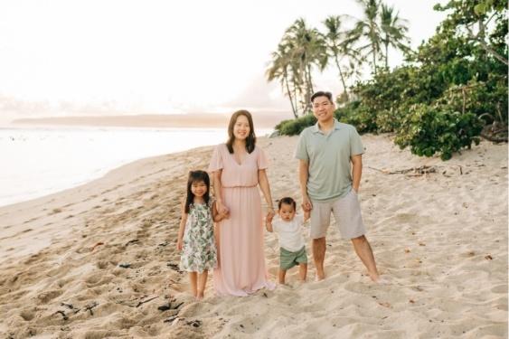 a family is posing for a picture on the beach .