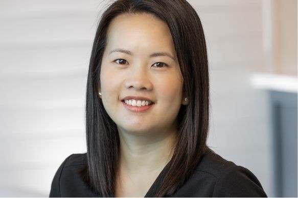 a woman with long dark hair is smiling for the camera .