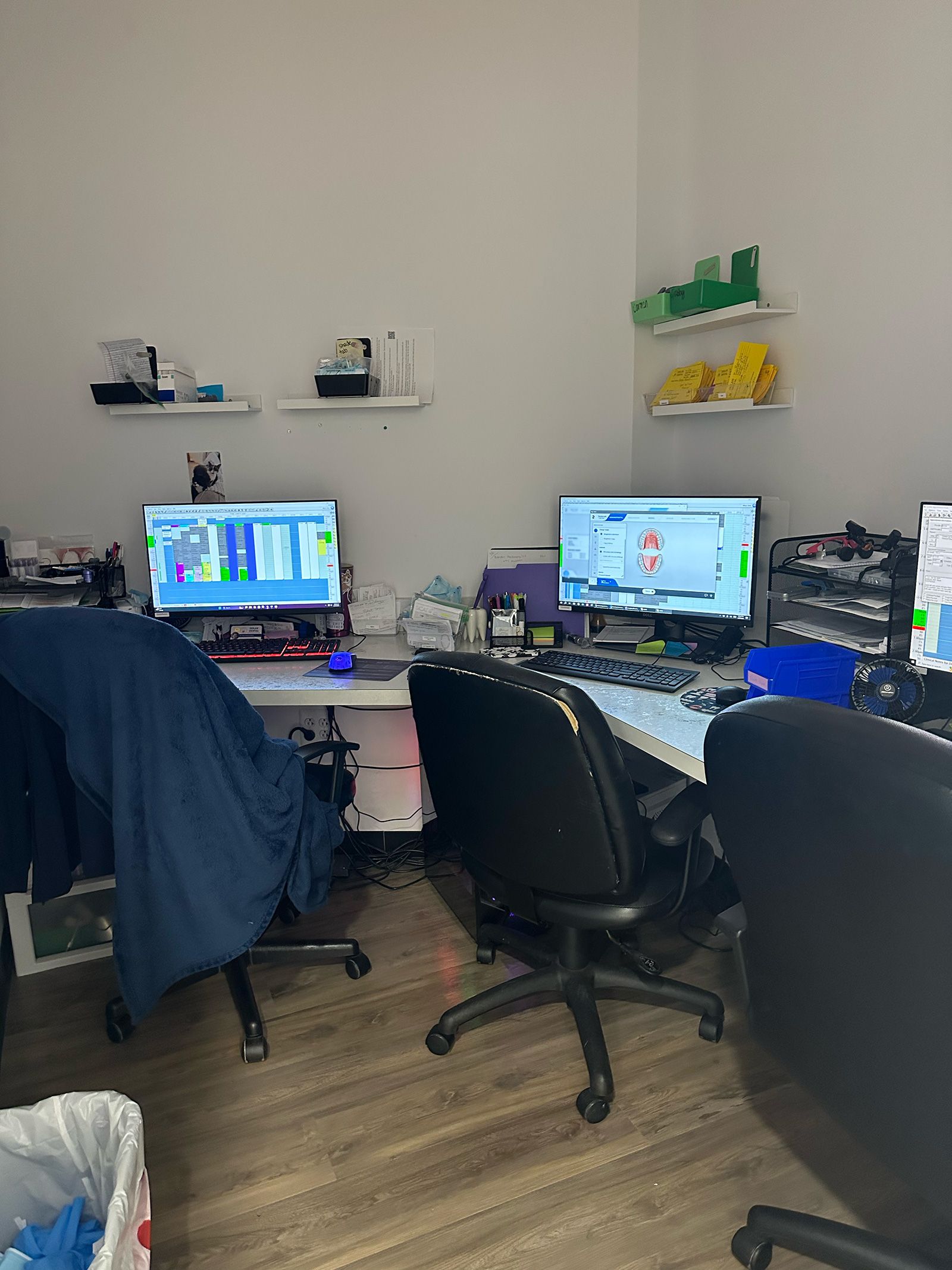 two computer monitors are on a desk in a room