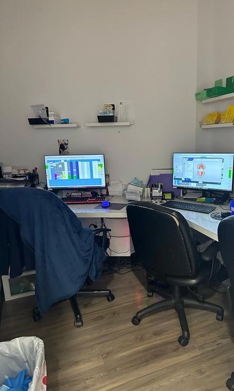 two computer monitors are on a desk in a room