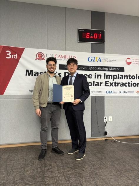 two men standing in front of a sign that says 3rd