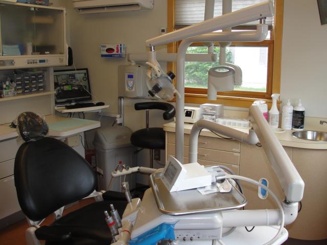 a dental office with a dental chair and a sink .
