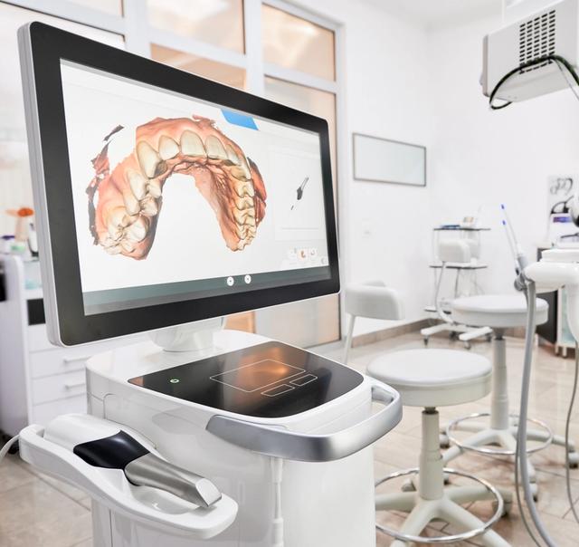 a dental office with a computer and a dental chair .
