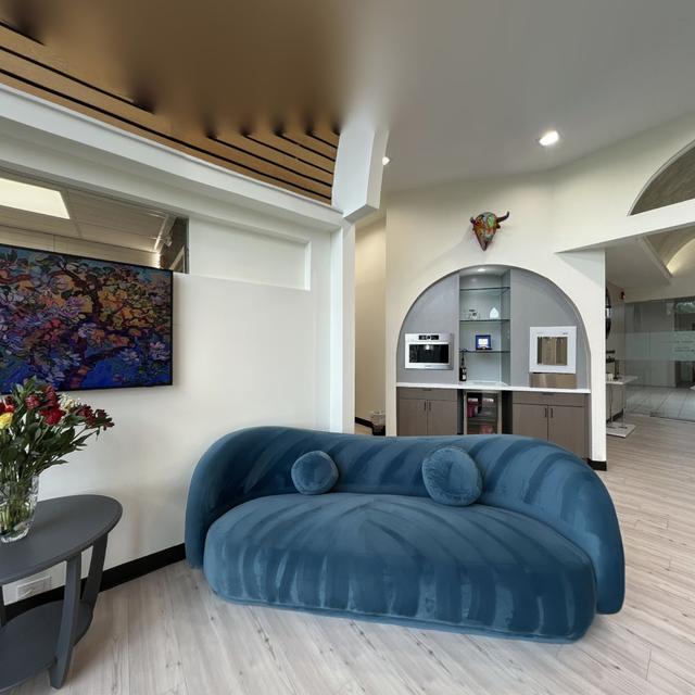 there is a blue couch in the middle of the room .