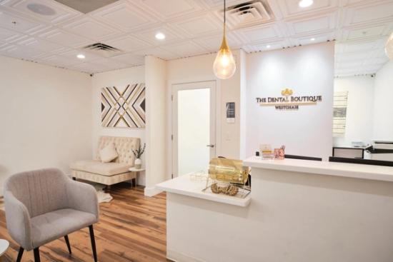 a dental office with a waiting room and a reception desk .