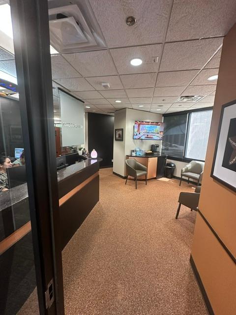 a woman is sitting at a desk in a waiting room .