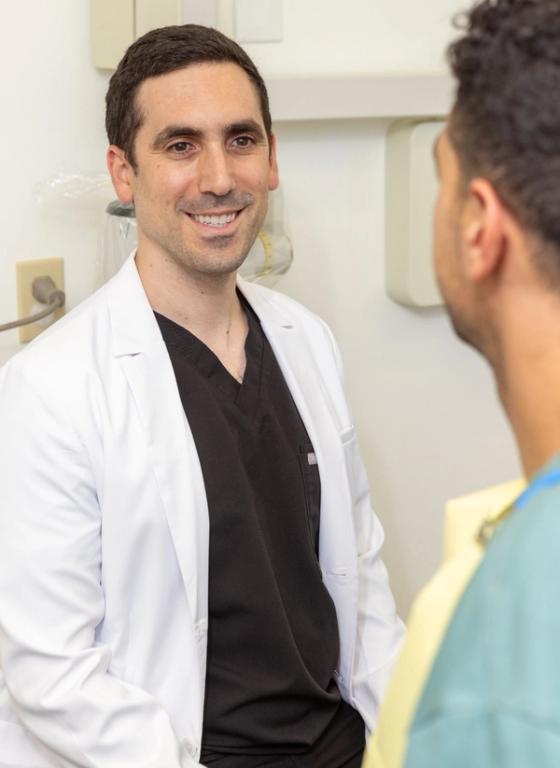 a doctor in a white coat is talking to a patient