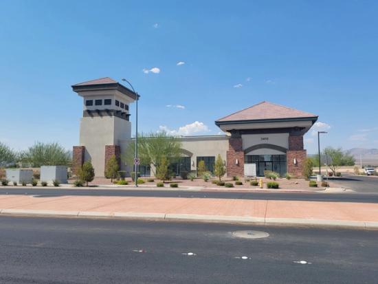 a large building with a tower on top of it is sitting on the side of a road .