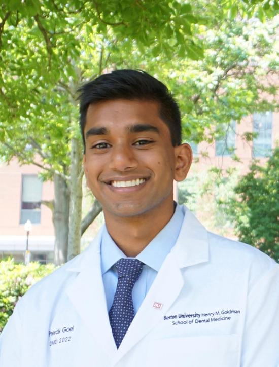 Young man Prerak Goel DMD 2022 smiling in a white lab coat from Boston University Henry M. Goldman School of Dental Medicine.