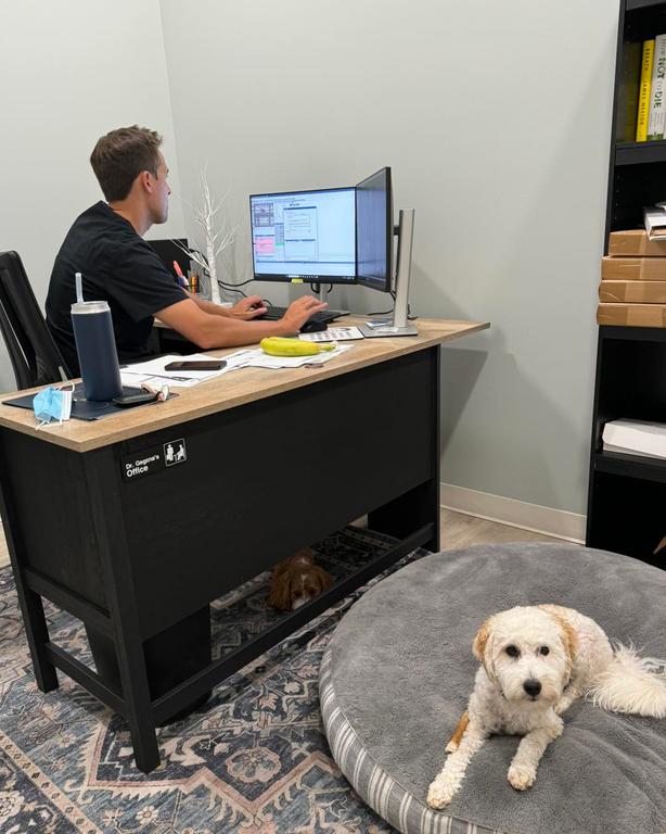 a woman is holding a model of her teeth and smiling .