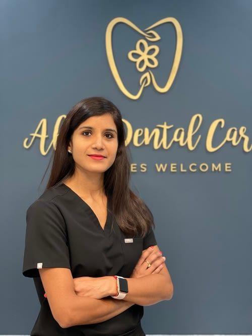 a woman stands in front of a sign that says all dental care