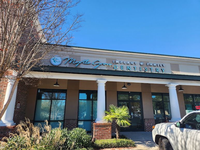 Exterior of "Myrtle Grove Implant & Family Dentistry" storefront.