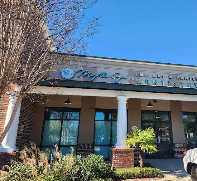Exterior of "Myrtle Grove Implant & Family Dentistry" storefront.