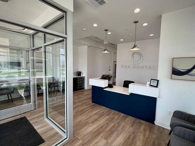 a dental office with a reception desk and a waiting room .