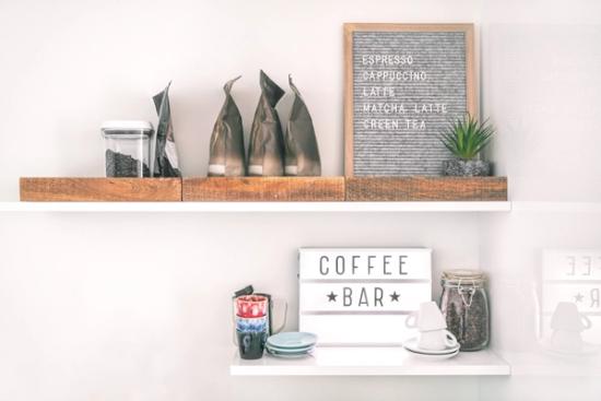 a white shelf with a sign that says `` coffee bar '' on it .