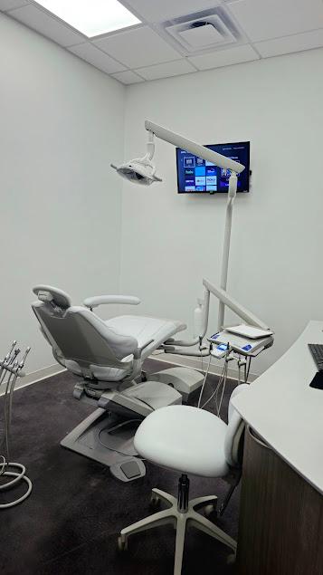 a waiting room with chairs and a coffee maker .