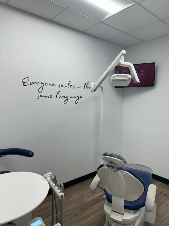 a dental office with a sign that says everyone smiles in the same language
