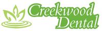 the logo for creekwood dental has a green leaf on it .