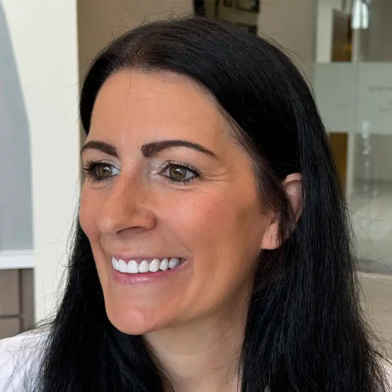 a close up of a woman 's face with a smile on her face