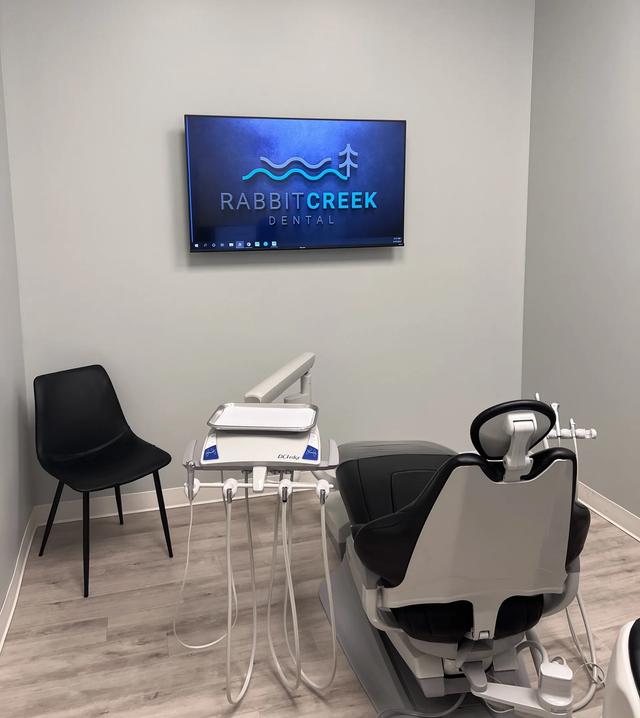 a dental office with a rabbit creek dental logo on the wall