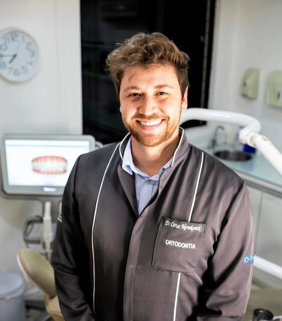 a man in a dental office with a name tag that says orthodontia