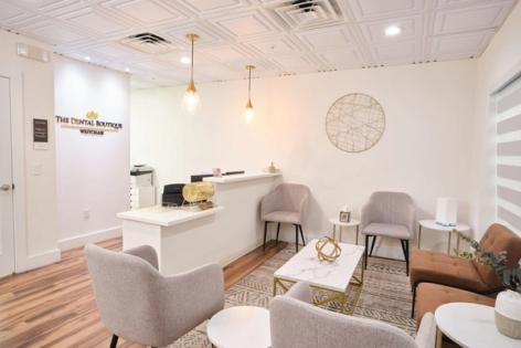 a dental office with a dental chair and a television .