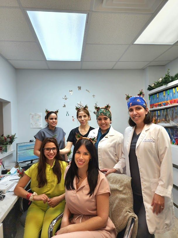 a group of female doctors are posing for a picture in a hospital .