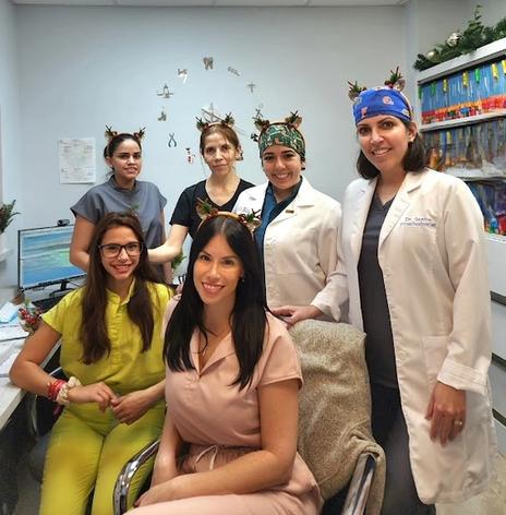 a group of female doctors are posing for a picture in a hospital .