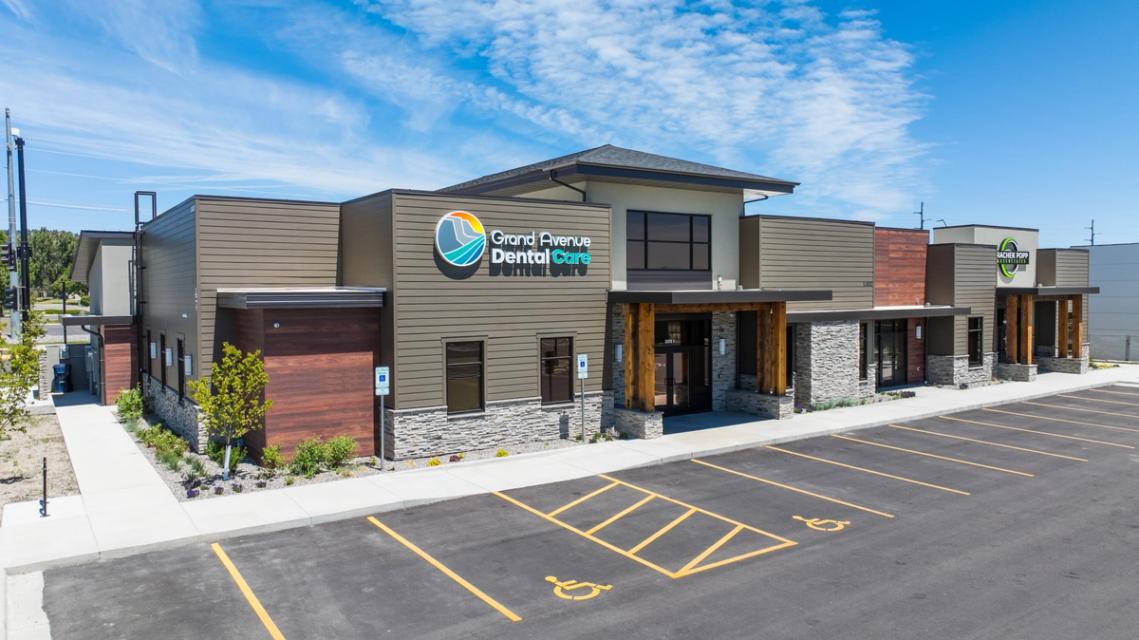 an aerial view of a dental office with a handicapped parking spot in front of it .