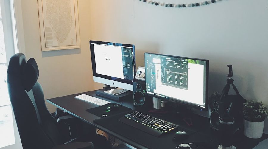 black flat screen computer monitor on brown wooden desk